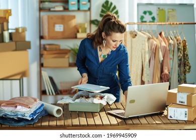 Young 40 Years Old Small Business Owner Woman With Clipboard Using Laptop In The Office.