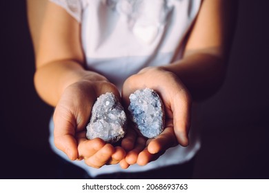 Young 7 Year Old Girl Child Holding Clusters Of Blue Crystals Called Celestite. An Indigo Child Concept, New Age Term.