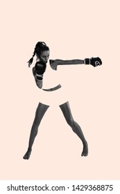 Young Active Beautiful Woman Full Of Energy With The Black Boxing Gloves Training And Practicing At The Studio. Creative Collage. Fitness, Boxing, Female Strenght, Sport, Motion And Movement Concept.