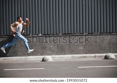 Similar – Athletic man warming up before running.