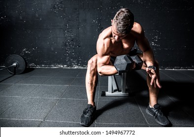 Young Active Strong Muscular Sweaty Fit Man Biceps Muscle Workout Cross Training With Heavy Dumbbell In The Gym Dark Image With Shadows Real People Exercising