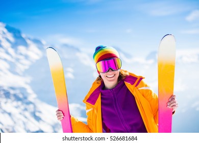 Young Active Woman Skiing In Mountains. Female Skier With Safety Helmet, Goggles And Poles Enjoying Sunny Winter Day In Swiss Alps. Ski Race For Adults. Winter And Snow Sport In Alpine Resort.