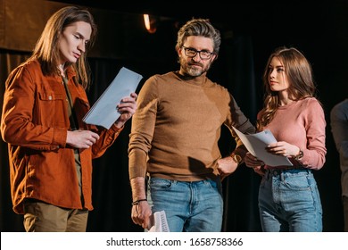 Young Actor And Actress On Rehearse With Mature Theater Director