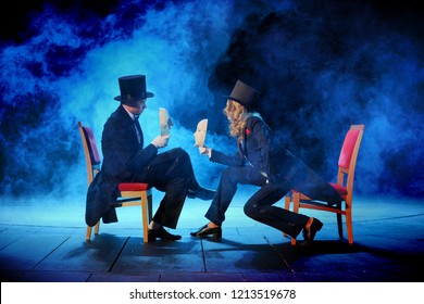 Young Actors In Tuxedos Holding Theatrical Masks