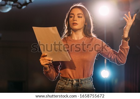 young actress reading scenario on stage in theatre Foto stock © 