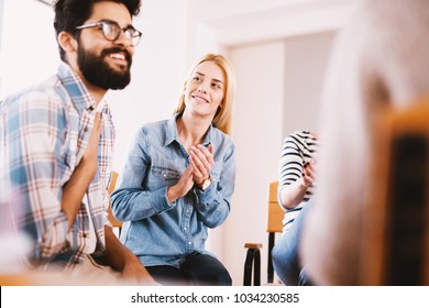 Young Addicted People Having Celebrating Situation While Sitting Together On Special Group Therapy. Handsome Hipster Guy Smiling After His Confession And Progress.