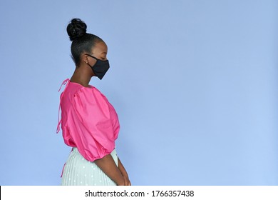 Young adult african american woman wearing stylish trendy fashion clothes and black cotton designed medical face mask standing isolated on lilac violet mauve studio background. Coronavirus protection. - Powered by Shutterstock