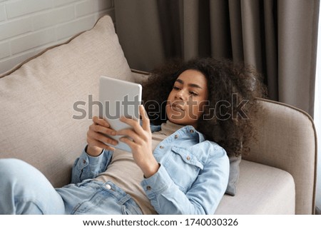 Similar – Image, Stock Photo Young adult woman lying in bed and with her cat and pile of books in her hands