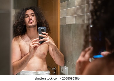 Young Adult With Afro Taking Selfie In Bathroom Mirror Shirtless