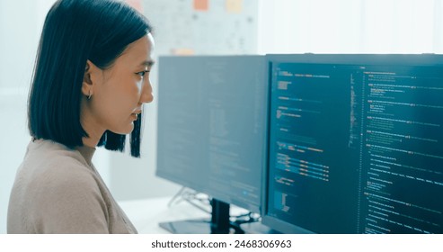 Young adult Asia female freelance typing write prompt AI bot IT app smart program nomad, video game, terminal with coding language, user interface, designer, big data center on desktop computer. - Powered by Shutterstock