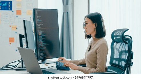 Young adult Asia female freelance eyeglasses typing write prompt AI bot IT app smart program nomad, video game, terminal with coding, user interface, designer, big data center on desktop computer. - Powered by Shutterstock