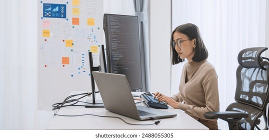 Young adult Asian female software developer coding program on desktop computer. Woman work from home, remote working, freelance programmer job, smart digital nomad lifestyle concept - Powered by Shutterstock - Get 15% off with code: PIKWIZARD15