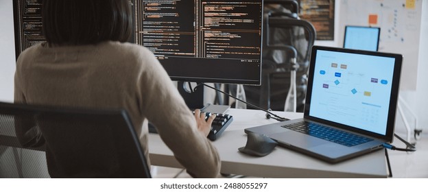 Young adult Asian male, female software developer coding program on desktop computer. Man, woman work from home, remote working, freelance programmer job, smart digital nomad lifestyle concept - Powered by Shutterstock