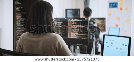 Young adult Asian male, female software developer coding program on desktop computer. Man, woman work from home, remote working, freelance programmer job, smart digital nomad lifestyle concept
