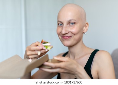Young adult beautiful caucasian bald shaved hair woman portrait enjoy eating sandwich for lunch at home indoor. Breast cancer survivor person nutrition healthy diet awareness. Chemoterapy alopecia - Shutterstock ID 1831717630