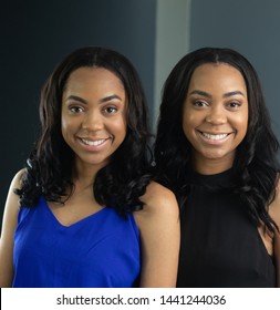 Young adult black female identical twins