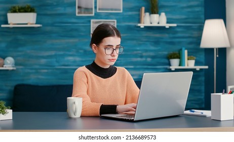 Young Adult Browsing Internet On Laptop To Do Remote School Work From Home. Woman Leaning Educational Course On Online Class Lesson, Using Computer To Plan Project Information.