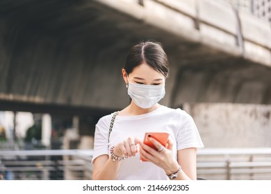 Young Adult Business Asian Woman Using Mobile Phone For Shopping Online Via Digital Wallet. Lifestyle With Technology. Single Businesswoman Wear Face Mask.