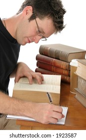 Young Adult Casually Dressed Male Studying Old Law Books.