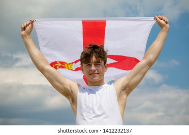 Young Adult Caucasian Male Holding On A Beach Holding The Flag Of Northern Ireland