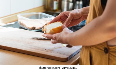 Young Adult Cooking Vegan Food With Onion