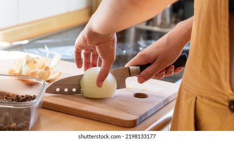 Young Adult Cooking Vegan Food With Onion