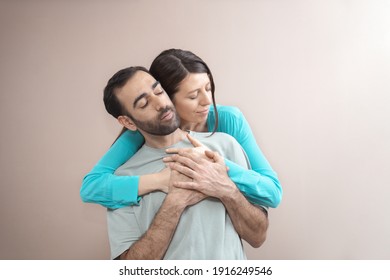 Young Adult Couple Hugging, Showing Love, Care, Expressing Emotions. Mixed Race, Brown Hair. Attractive People, Closeup Portrait. Studio Shot, Commercial, Advertising Concept