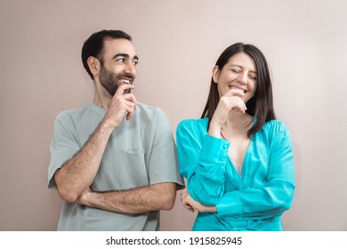 Young Adult Couple Laughing, Expressing Emotions. Mixed Race, Brown Hair. Attractive People, Closeup Portrait. Studio Shot, Commercial, Advertising Concept