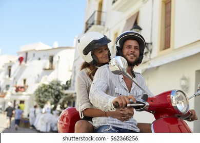 Young Adult Couple On A Motor Scooter In A Street, Ibiza