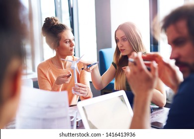 Young Adult Coworkers Having A Conversation In Office Meeting 