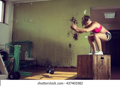 Young Adult Crossfit Girl Jumping On Box In Gym Club.