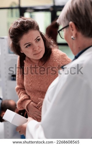 Similar – Female doctor filling out questionnaire to a senior patient