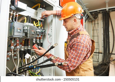 young adult electrician builder engineer worker in front of fuse switch board - Powered by Shutterstock