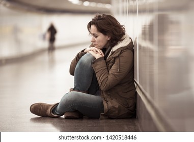 Young adult felling shame depressed and hopeless sitting alone on subway city ground in Depression Loneliness Mental health Emotional pain Social violence Abusive relationship and Harassment concept.
