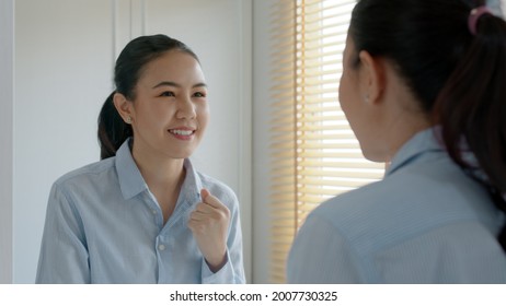 Young Adult Female Asia People Self Love Cheer Up Pep Talk Before Job Interview Deep Breathe Inhale Standing Look In Front Of Mirror Smile At Home In Mental Health Care Or Work Career Stress Relief.