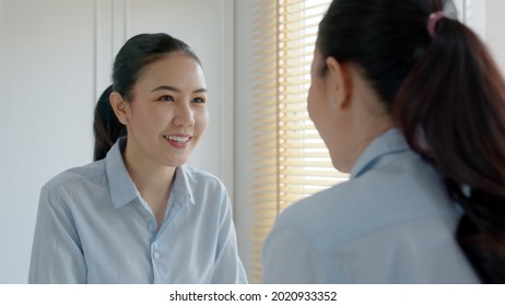 Young Adult Female Asia People Self Love Cheer Up Pep Talk Before Job Interview Deep Breathe Inhale Standing Look In Front Of Mirror Smile At Home In Mental Health Care Or Work Career Stress Relief.