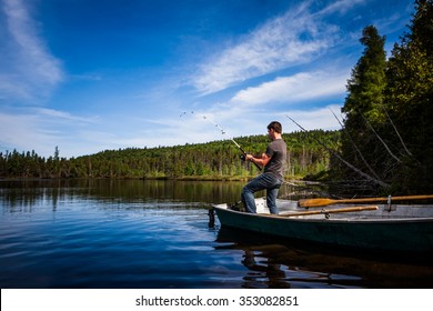 Young Adult Fishing trout from a deck in a calm Lake during the morning - Powered by Shutterstock