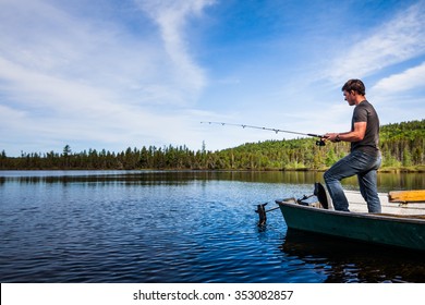 Young Adult Fishing trout from a deck in a calm Lake during the morning - Powered by Shutterstock