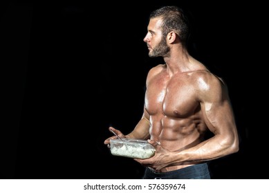 Young Adult Fit Muscular Bodybuilder Eating Healthy White Rice From Plastic Dish Isolated.