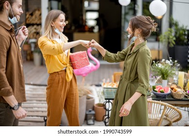 Young Adult Friends Gathering For Birthday Party At The Backyard Of Country House. Wearing Face Masks And Greet With Social Distance, New Normal During Pandemic