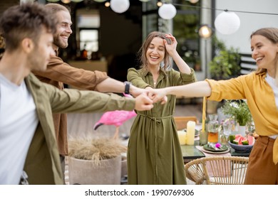 Young Adult Friends Gathering For Birthday Party At The Backyard Of Country House. Wearing Face Masks And Greet With Social Distance, New Normal During Pandemic