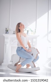 Young Adult Girl On A Rocking Horse / Unusual Photo Of A Girl In The Studio Funny Laugh