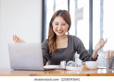 Young adult happy smiling Hispanic Asian student video calling on laptop or doing video chat by webcam in university campus or virtual  at office. College female student learning remotely. - Shutterstock ID 2258593641