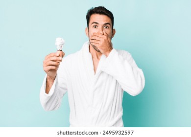 young adult hispanic man covering mouth with hands with a shocked. shaving concept - Powered by Shutterstock