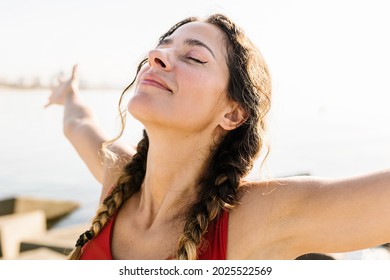 Young Adult Hispanic Woman Breathing Fresh Air Standing On The Beach At Summer - Portrait Of Sportive Hispanic Female Relaxing By The Sea - Wellness And Healthcare Lifestyle Concept