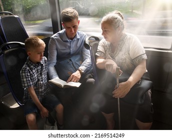 Young adult male guy father teach kid son help sit seat hand hold look old age female lady. Ask give offer flyer human Jesus Christ church faith save street train trip life group culture sunny summer