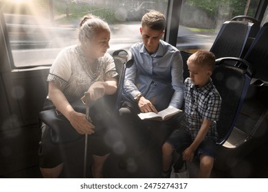 Young adult male guy father teach kid son help sit seat hand hold look old age female lady. Ask give offer flyer human Jesus Christ church faith save street train trip life group culture sunny summer - Powered by Shutterstock