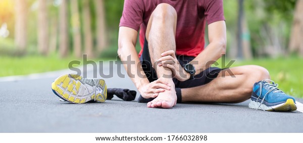 Young adult male with his\
muscle pain during running. runner man having leg ache due to Ankle\
Sprains or Achilles Tendonitis. Sports injuries and medical\
concept
