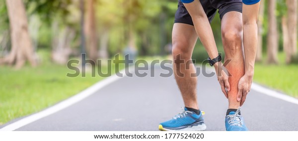 Young adult male with his muscle pain during\
running. runner man having leg ache due to Shin Splints. Sports\
injuries and medical\
concept