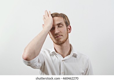 Young Adult Male Wearing White Shirt Gesturing He Has Made a Big Mistake